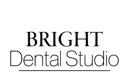 The image is a graphic with a black background featuring a white tooth with a hole in the center, and above it, there s text that reads  your family caring for your smile.
